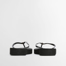 Rear view of black flip flops showing squared heel shape and raised sole height