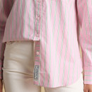 Mid-section view of a pink striped women’s shirt with front buttons and vertical green and white stripes, paired with cream trousers.