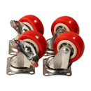 Four metal caster wheels with shiny red rubber tires are arranged in a cluster. The wheels have metal brackets and mounting plates, conveying functionality.