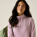 Close-up of the lilac half-zip fleece showing the high collar, zip and embroidered chest logo.