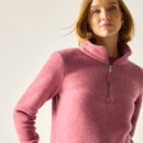 Close-up angled view showing the pink half-zip fleece top’s textured fabric and high collar.