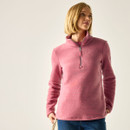 Model wearing a pink long-sleeve fleece top with a high neck and half-zip, looking to the side against a light background.