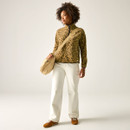 Full-length view of model in the tan leopard print half-zip fleece with cream trousers, brown trainers and beige crossbody bag.
