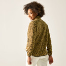 Back view of model wearing the tan leopard print half-zip fleece with cream trousers.