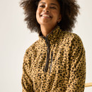 Close-up of model wearing the tan leopard print half-zip fleece, showing the high collar and chest zip detail.