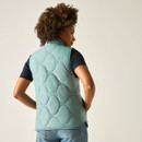 Back view of a woman wearing an ivy green quilted gilet over a black T-shirt and blue jeans.