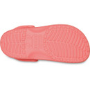 Underside of a guava pink Crocs Classic Clog displaying the tread pattern and embossed Crocs branding on the sole.
