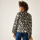 Back view of model wearing the cream and black floral quilted jacket, showing the all-over floral pattern.