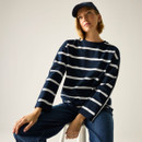 Model wearing a navy long-sleeve top with white horizontal stripes, seated and looking up, studio background.