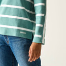 Close-up of the hem and sleeve of the green and white striped top, showing the Regatta logo and side split detail.