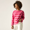 Model wearing a pink long-sleeved top with bold red horizontal stripes, paired with white trousers.