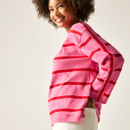 Side view of model in pink long-sleeved top with red stripes, showing the relaxed fit.