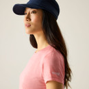Close-up side view showing the peach marl T-shirt fabric and the Regatta logo on the sleeve, worn with a navy cap.