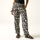Close-up of black and cream printed wide-leg trousers showing the elasticated waist and straight-leg fit.