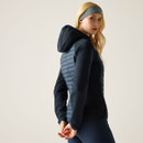 Side view of a navy hybrid padded jacket worn by a model, showing the fitted shape and hood.