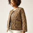 Side view of the model wearing the tan leopard-print quilted jacket, showing the open front and pocket detail.