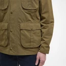 Close-up of a person wearing an olive-green utility jacket with large flap pockets and button details. The background is plain white, conveying a casual, outdoorsy vibe.