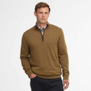 Man in a brown jumper with a half-zip design over a plaid shirt. He exudes a casual, confident demeanour, set against a plain white background.