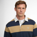 A man poses against a light background, wearing a navy and tan striped rugby shirt with a white collar. His expression is calm and composed.