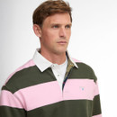 Man with short brown hair wearing a pink and olive green striped rugby shirt with a white collar, looking thoughtfully to the side.