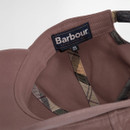 Close-up of a brown cap's interior, featuring a "Barbour" label and plaid trim. The tag indicates "One Size," conveying a casual, stylish tone.