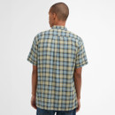Rearview of a person wearing a plaid short-sleeve shirt in blue and beige tones. The background is plain white, conveying a neutral tone.