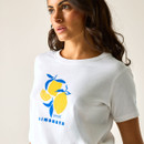 Side close-up of a woman wearing a white “Limonata” graphic T-shirt, highlighting the lemon design on the chest.