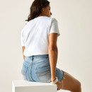 Rear view of a woman wearing a white short-sleeve T-shirt and denim shorts, showing the plain back of the T-shirt.