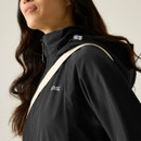 Side close-up of the black waterproof jacket showing the chest logo, shoulder detail and hood adjuster.