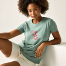 Close-up of a woman seated wearing a green graphic T-shirt with a floral print.