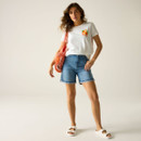 Full-length view of a model wearing a white T-shirt with orange chest print, denim shorts and white sandals, carrying a red mesh bag.