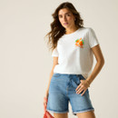 Model wearing a white short-sleeve T-shirt with a small orange graphic on the chest, styled with denim shorts.