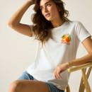 Close-up of the white T-shirt showing the orange fruit graphic on the chest, worn with denim shorts.