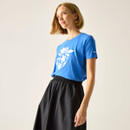 Side view of a woman wearing a blue short-sleeve T-shirt with white floral graphic.