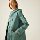Angled side view of women’s ivy moss green hooded waterproof jacket.