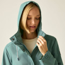 Women’s ivy moss green waterproof jacket with hood up, close-up view.