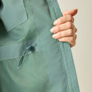 Close-up of adjustable waist drawcord on ivy moss green waterproof jacket.