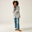 Women’s light grey waterproof jacket styled with jeans, full-body view.