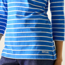 Close-up of women’s blue and white striped long-sleeve t-shirt hem with Regatta logo.