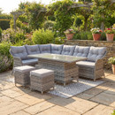 Florida grey rattan rectangular corner sofa set with rising table and cushions in landscaped garden setting