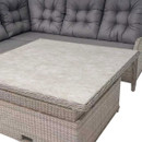 Grey cushioned wicker sofa set with a matching large wicker table featuring a smooth, light-coloured surface. The setup exudes a modern, cosy vibe.