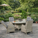 Rattan outdoor dining set with four reclining cushioned chairs around a round table with wine bottles on a garden patio.