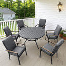 Stylish backyard patio set with six cushioned grey chairs surrounding a round, dark wood table. Bright, serene greenery and a cosy house in the background.