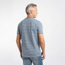Back view of a model wearing the blue striped T-shirt in a studio setting.
