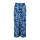 Back view of blue indigo wide-leg cropped trousers with an all-over tropical leaf print and elasticated waistband.