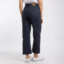 Back view of woman wearing navy cropped jeans and white trainers, showing rear pocket detail.