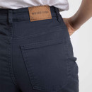 Close-up of navy cropped jeans showing back pocket stitching and Weird Fish leather patch.