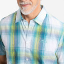 Close-up of the teal, blue and yellow check shirt collar and buttons with embroidered logo on the chest.