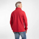 Rear view of model wearing a red half-zip sweatshirt and light blue jeans against a white background.