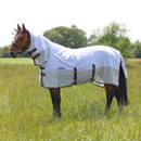 Horse wearing a white fly rug with mesh panels and neck cover, standing in a grassy field in summer.